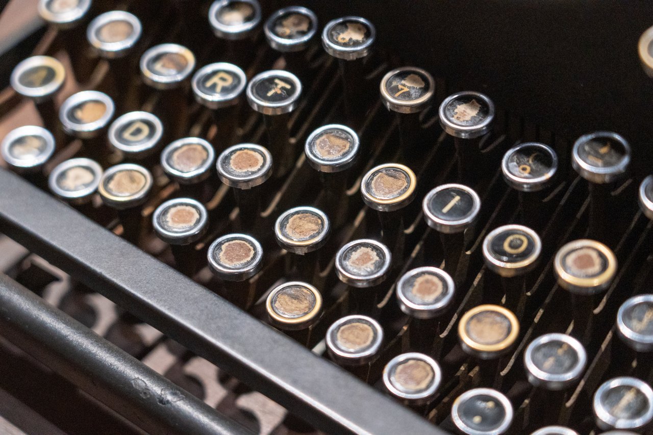 Detailed view of antique typewriter keyboard showing aged keys.